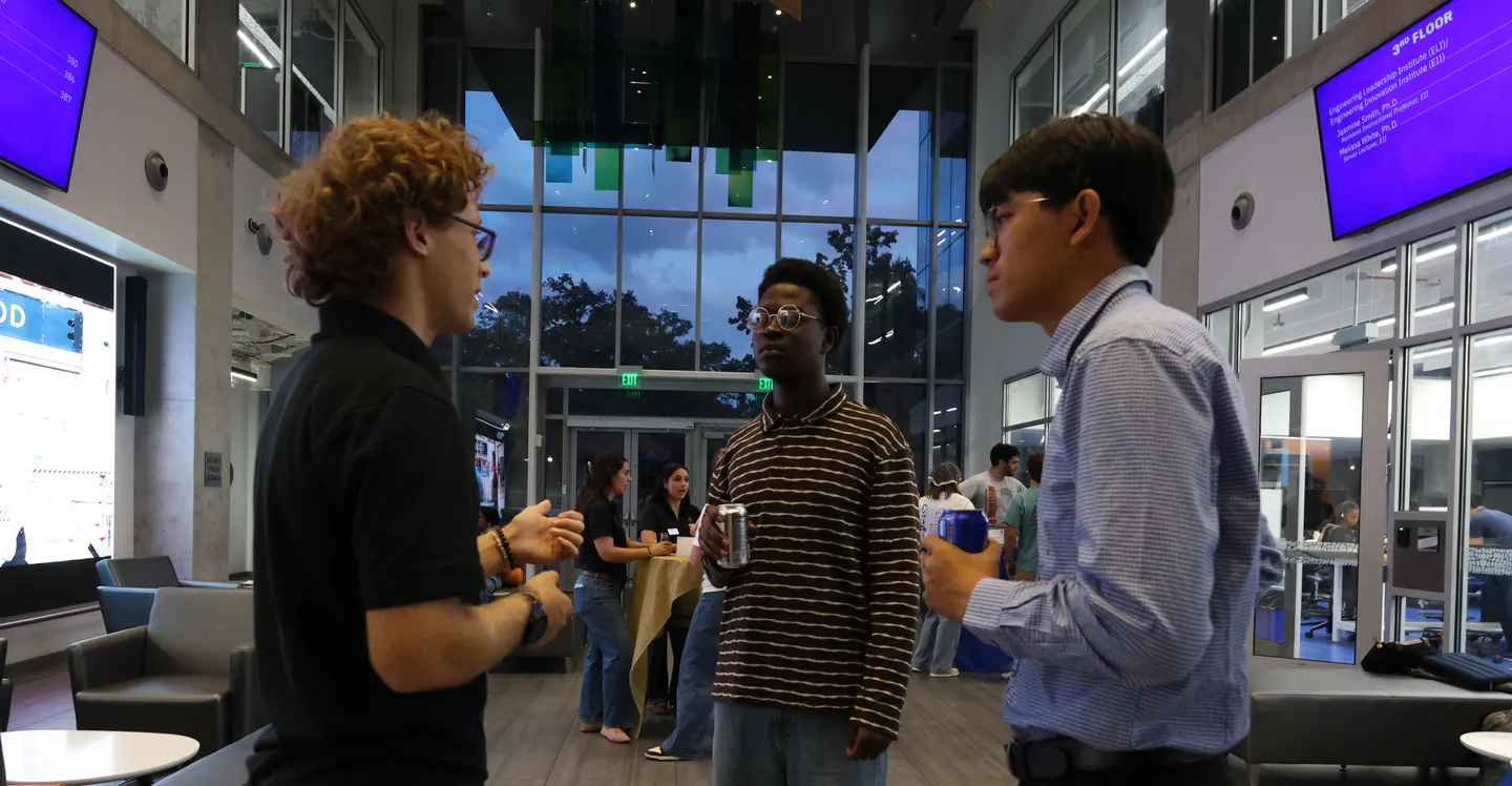Three attendees talking in the atrium during ELC’s Fall 2026 Leadership Summit.