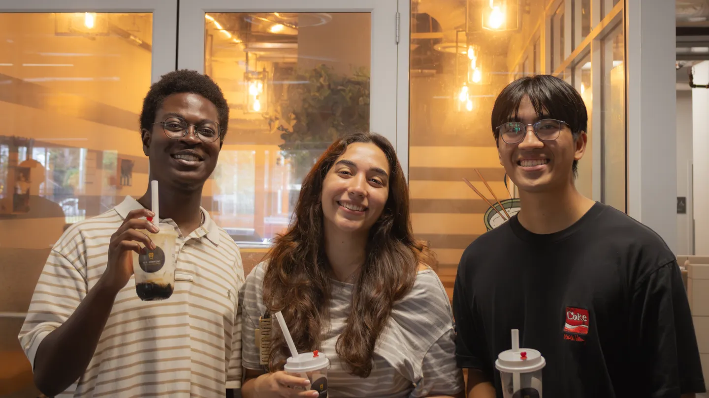 Three attendees smiling with their drinks at ELC’s 2026 Boba Social.