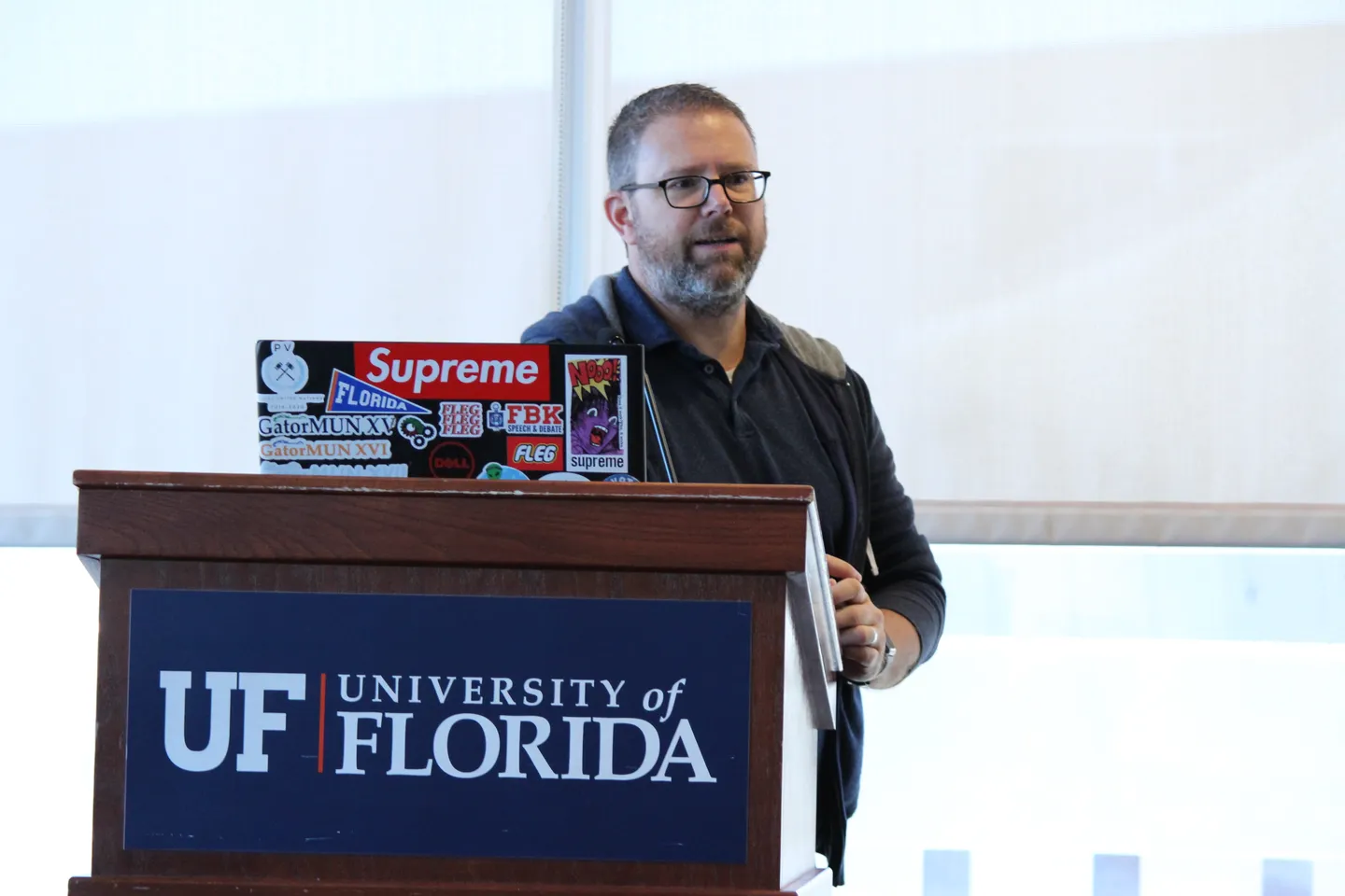 A speaker addressing attendees from a University of Florida podium at ELC’s Fall Flagship.